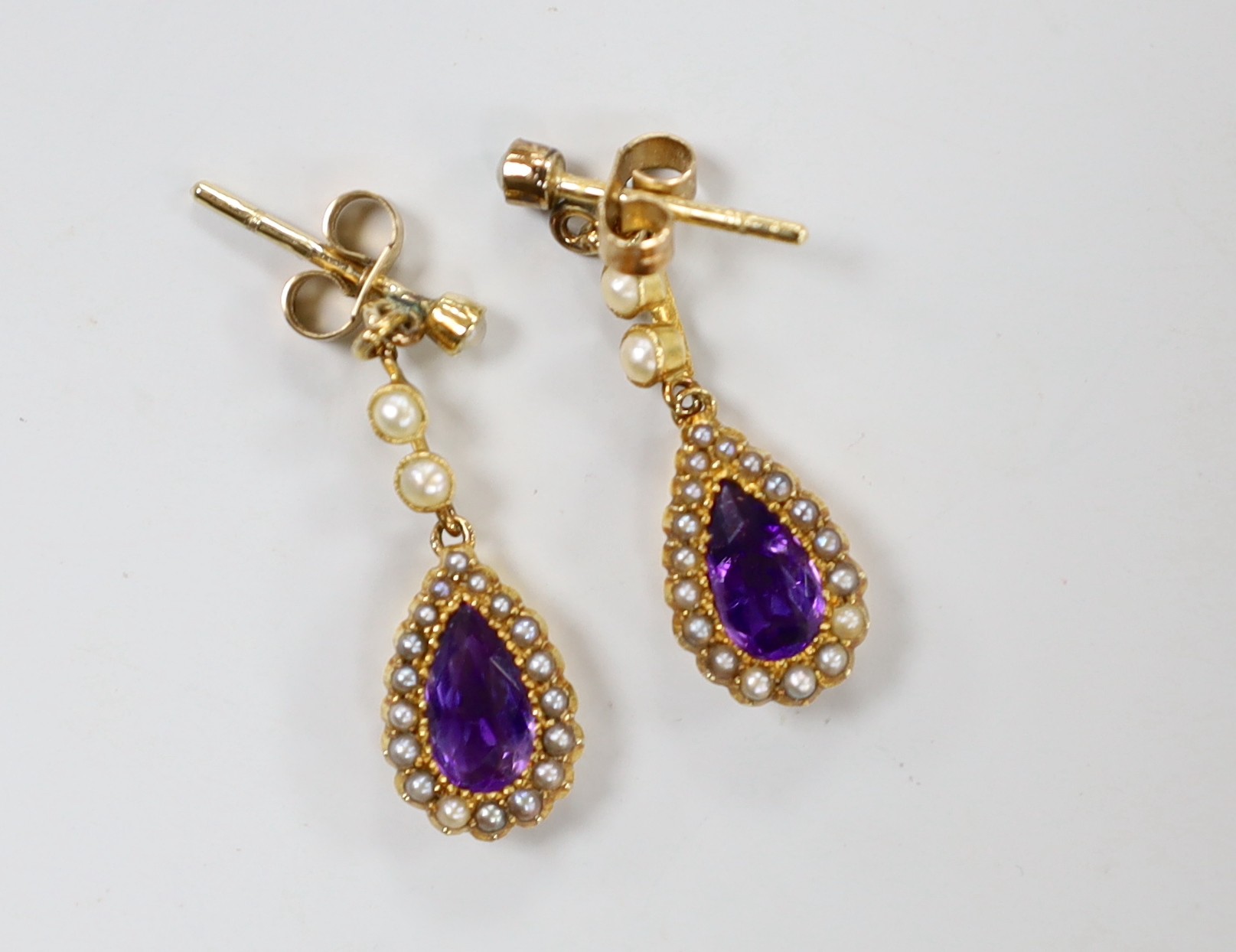 A pair of late Victorian, 15ct, amethyst and seed pearl set drop earrings, 29mm, gross weight 3.5 grams.